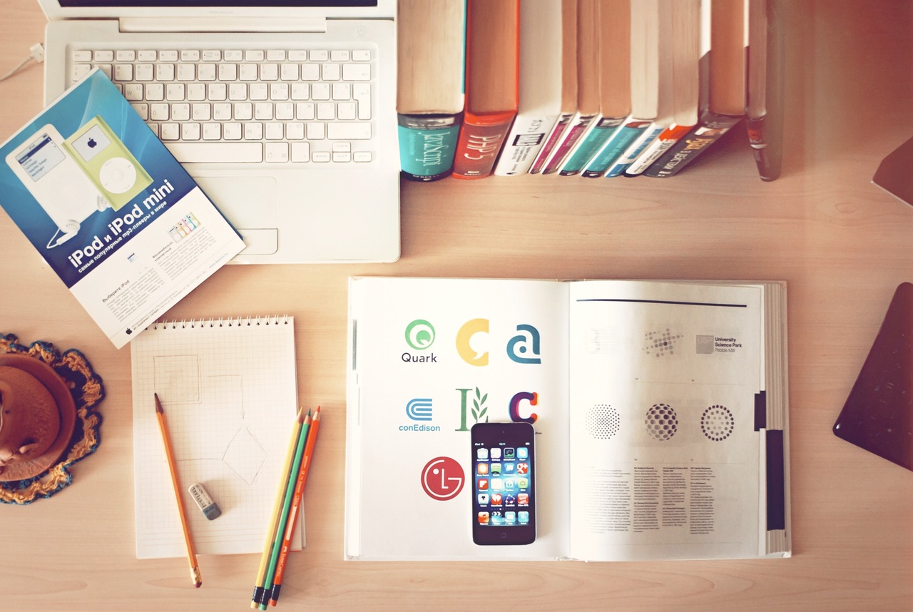 Desk with school books and laptop.