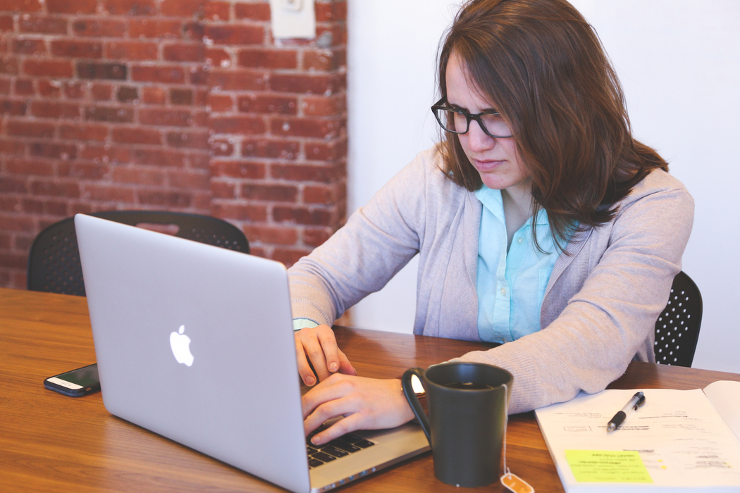 Woman working on Apple macbook